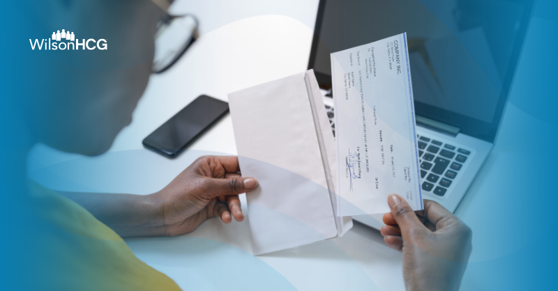 African American woman opens a check.