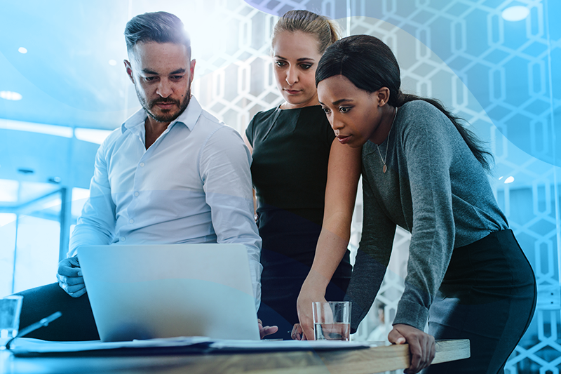 Group of people surrounding a laptop