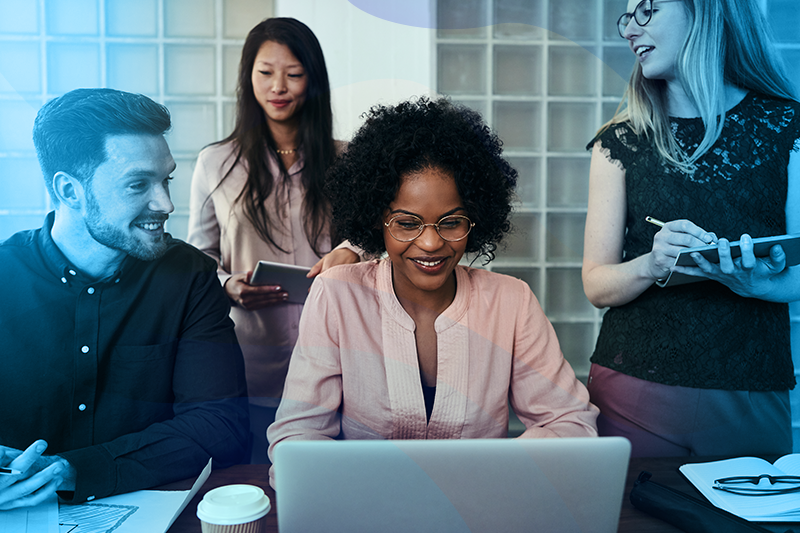 Group of workers around a laptop