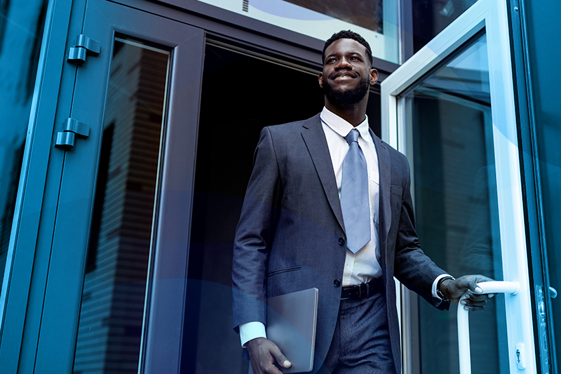 photo of a young businessman exiting a building