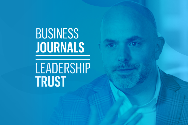 Ken Bowles, CFO at WilsonHCG, next to Business Journals Leadership Trust Logo