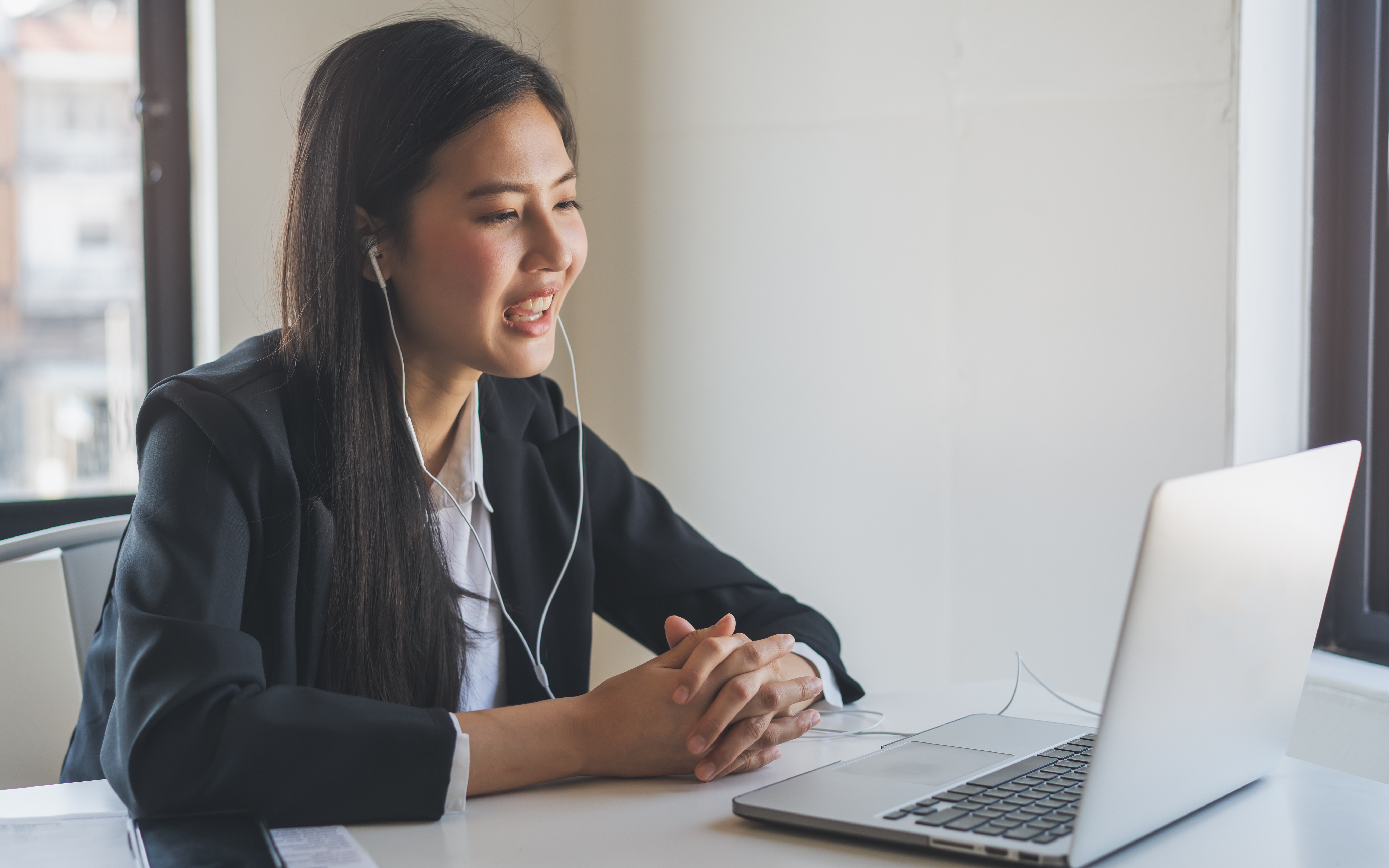 Woman on a laptop doing a video interview