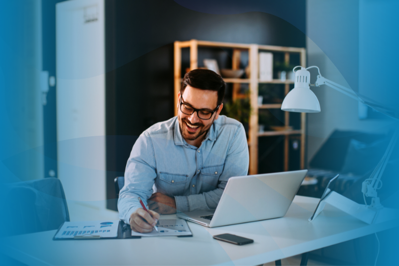 Young business man working at home with laptop and papers on desk