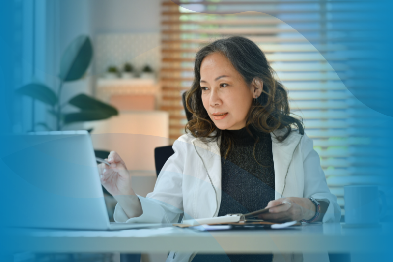 Mature Asian businesswoman using a laptop.