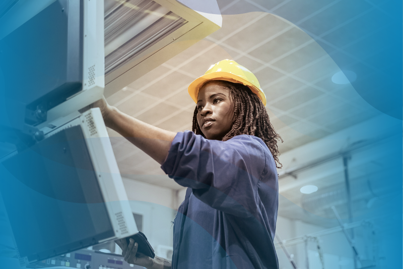 Black woman in manufacturing plant on a computer