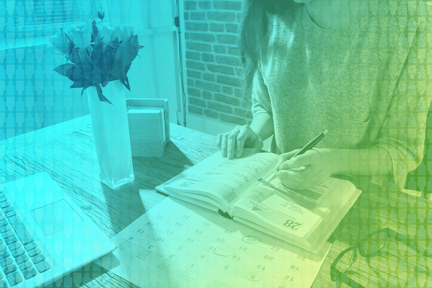 color-treated photo of a person working in a planner