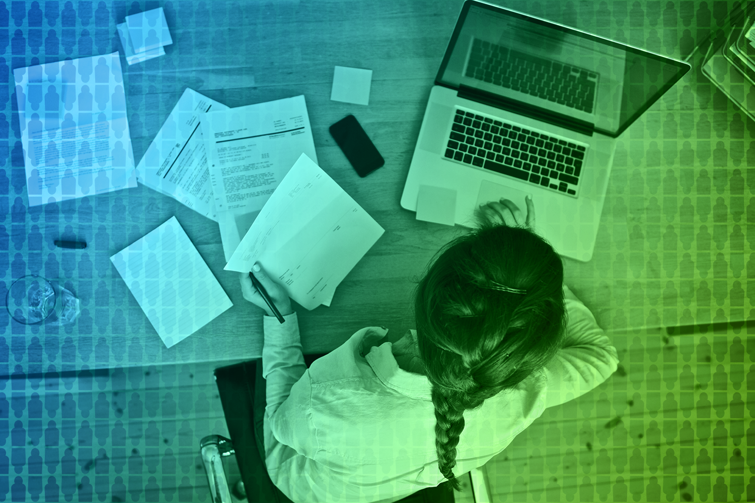 overhead shot of woman working on laptop in her home office