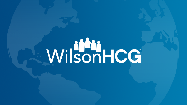 White WilsonHCG logo with a globe behind it with a blue gradient