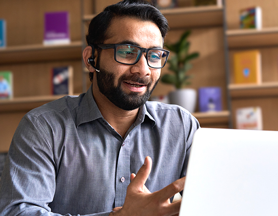 A man wearing glasses reading about direct sourcing and MSP on a laptop A man wearing glasses reading about direct sourcing and MSP on a laptop