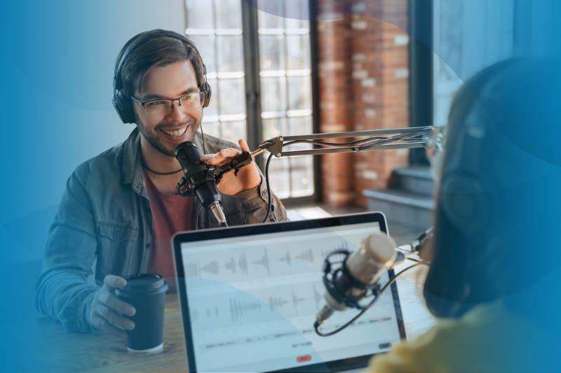 Two people using laptop, headphones and audio equipment for making podcast.