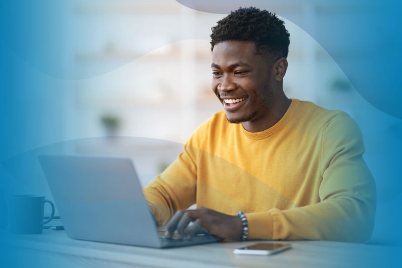 Black male working remotely and chatting with coworkers.