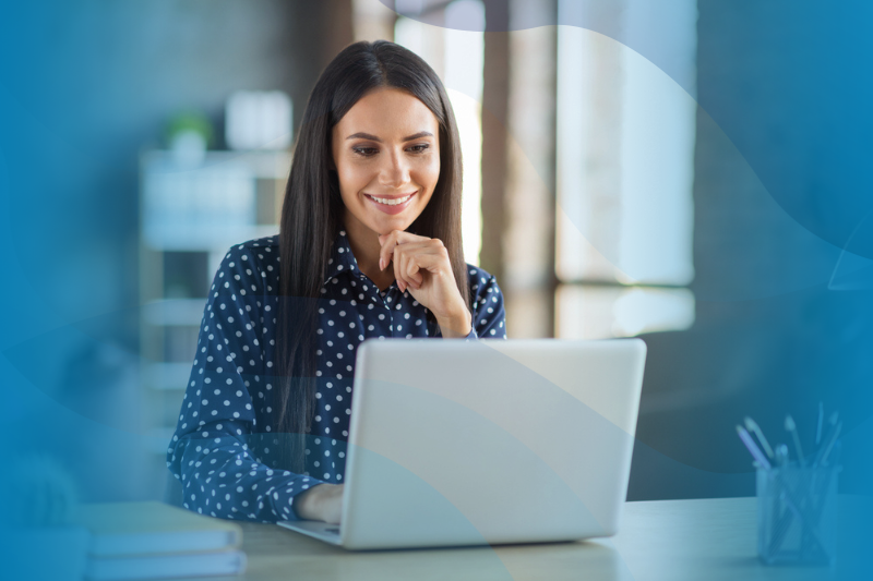 Businesswoman working on end-of-year financial reports on laptop.