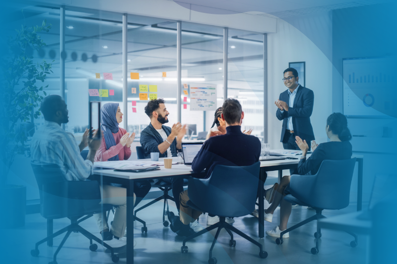 Indian CEO Does Presentation For Diverse Young Entrepreneurs At Conference Table