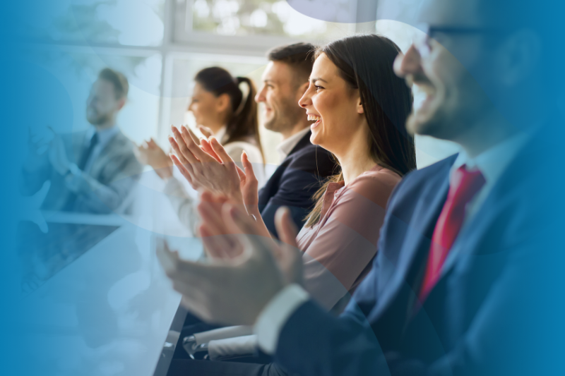 Group Of People Around A Conference Table Applauding