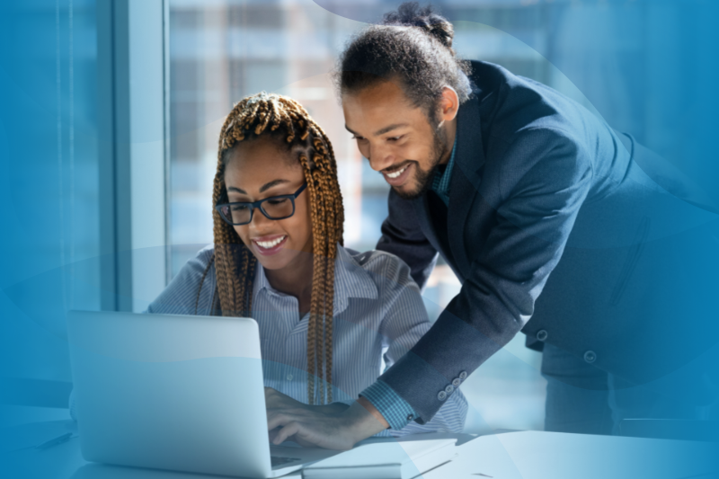 Male African American Manager Helping Female Biracial Colleague With Laptop