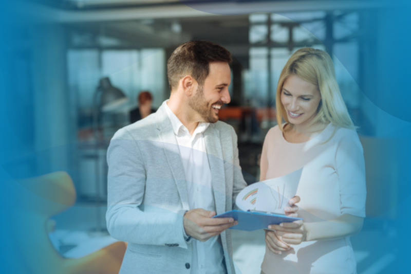 Two Business People Reviewing Trend Analysis Papers