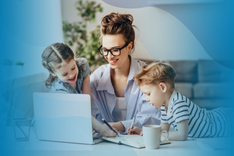 Mother Working Remotely At A Laptop With Son And Daughter At Home