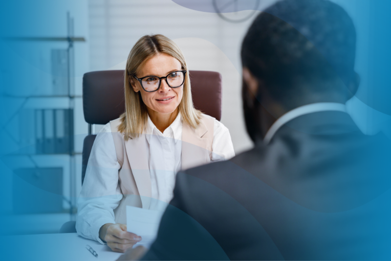 White business woman interviews an African American man.