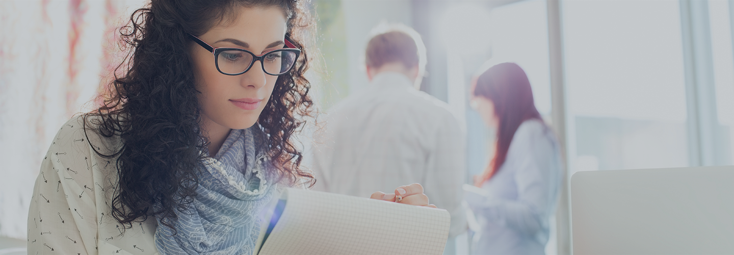 Woman overlooking a resume with people walking away in the background