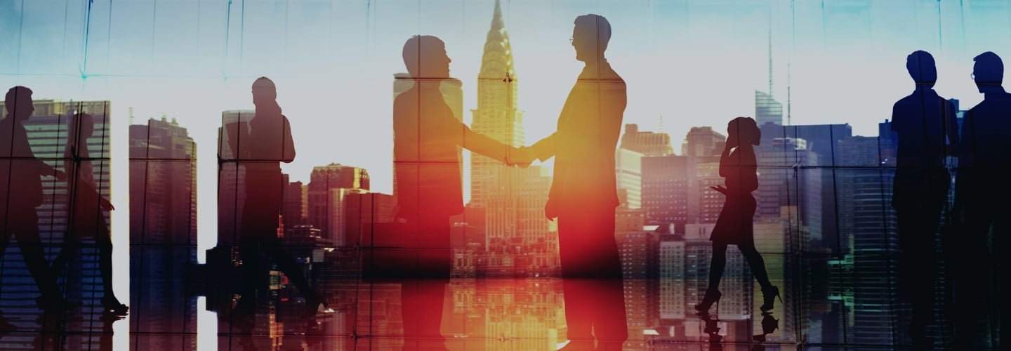 People shaking hands with a superimposed city background