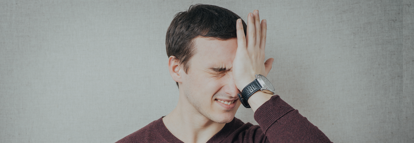 Man slapping his forehead with the palm of his hand