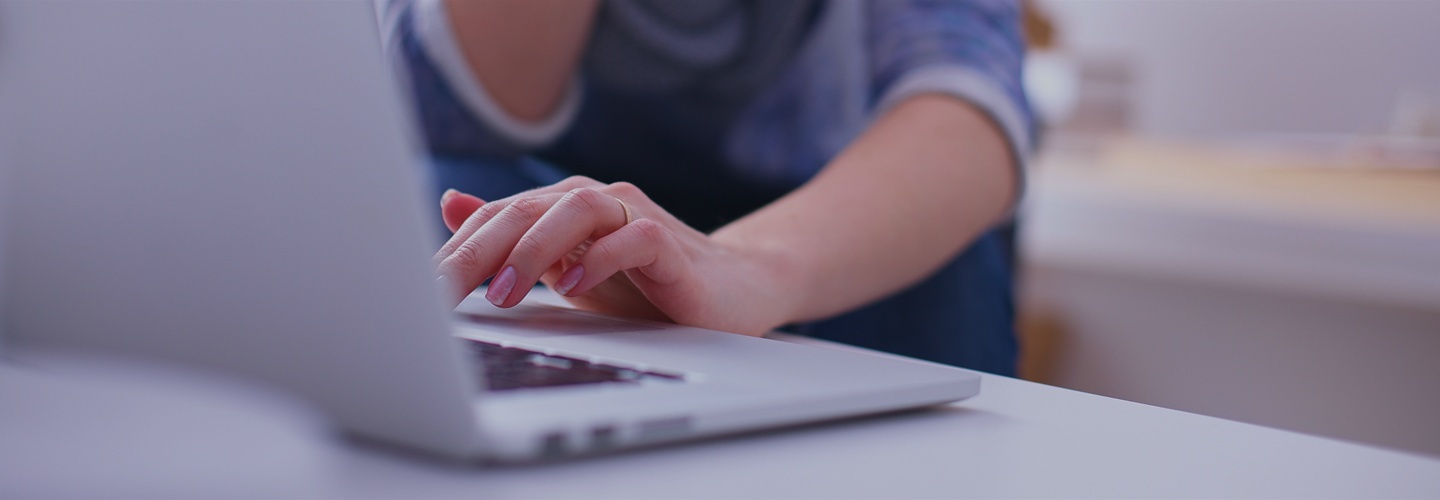 Someone typing on a laptop