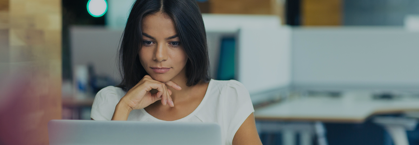 Woman looking intently at her laptop