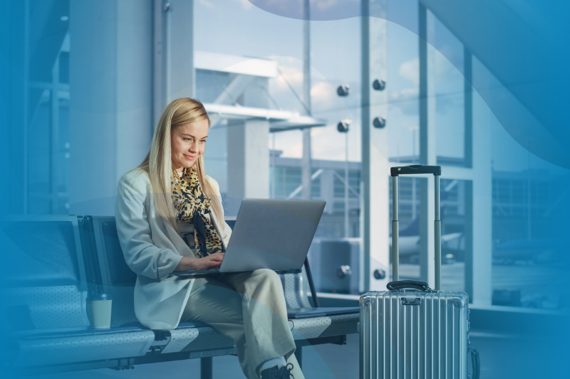  Smiling Woman Uses Laptop While Waiting for Flight