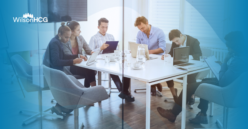 Group of people at the office working on laptops and tablets