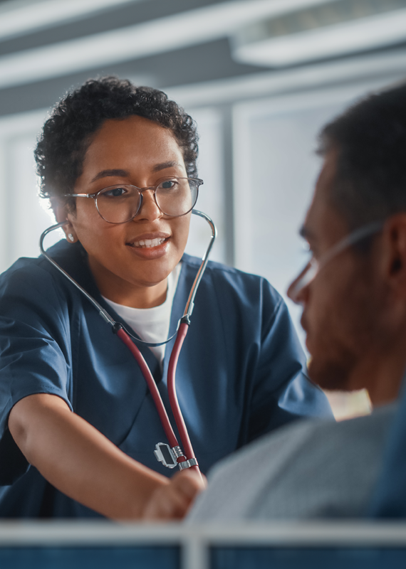 Healthcare employee hired by WilsonHCG's RPO team speaking to a patient