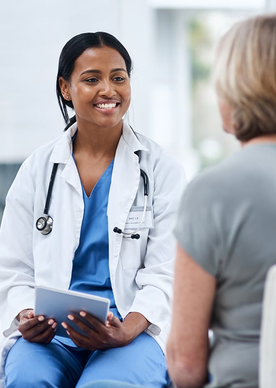  Female doctor in a white coat in a consultation with a female patient